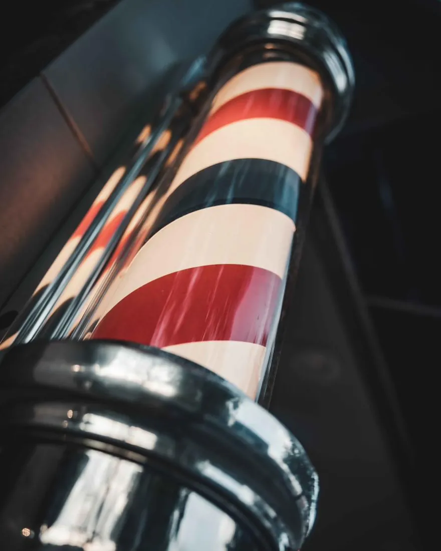 Close-up of a red, white and blue barber pole
