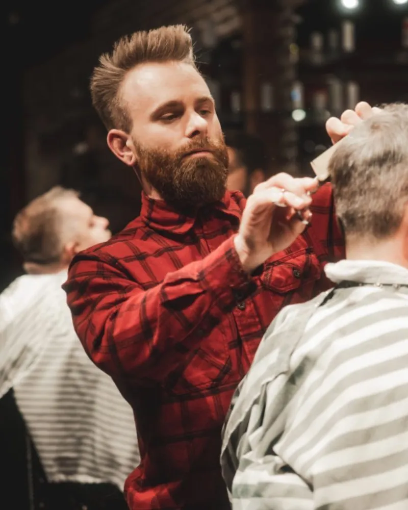 Austin, a senior barber at City Barbers, at work