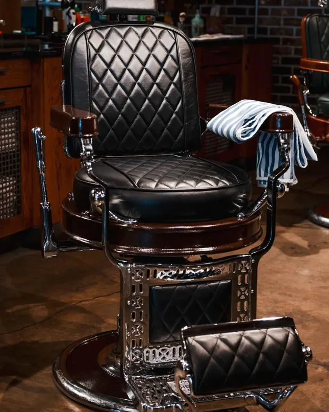 A black tufted barber chair