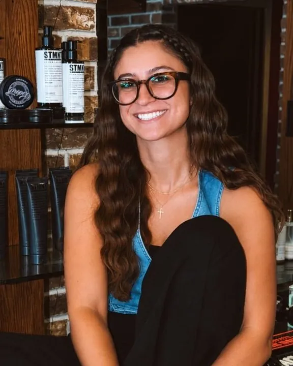 Sophia, a barber at City Barbers, at her station