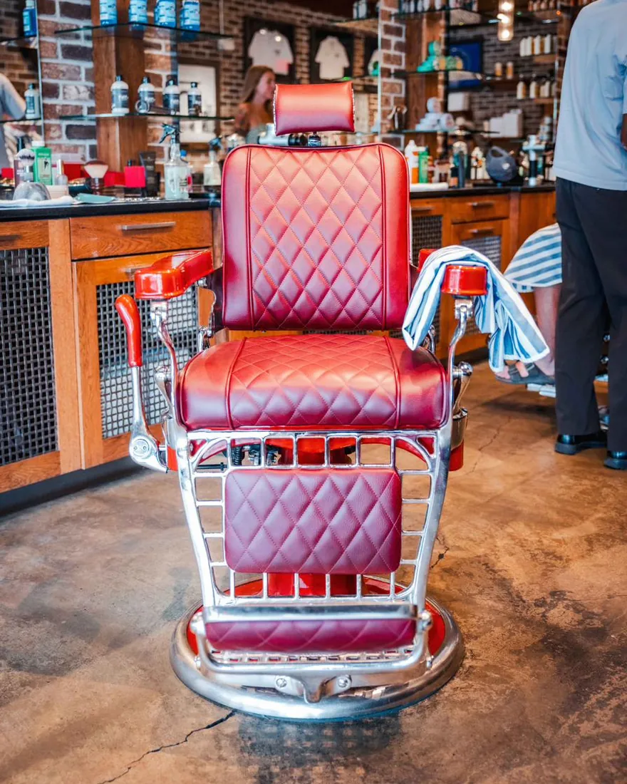 A red leather barber chair at its station