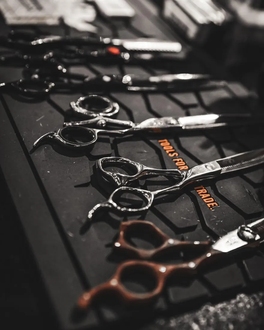 Barber shears laid out on a mat